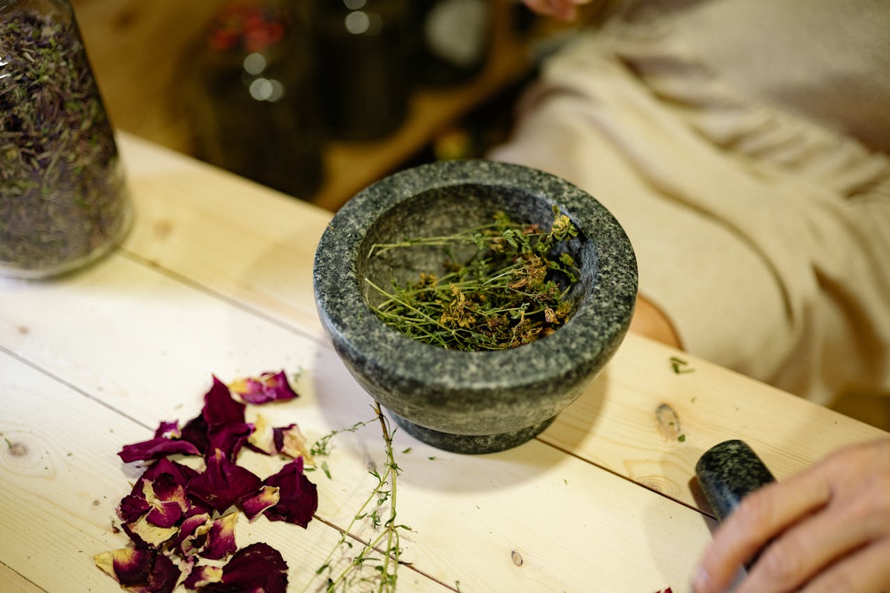 services-02 Close-up of dried herbs in a mortar and pestle for natural healing.